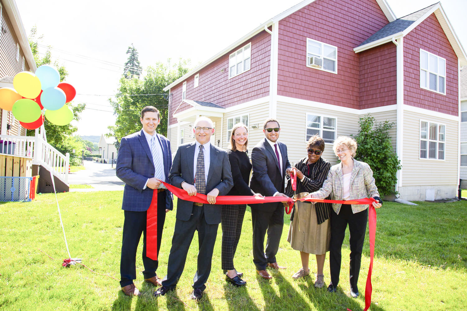 Local officials and Johanna Anderson of INHS celebrate Village Grove. (Photo: Provided)